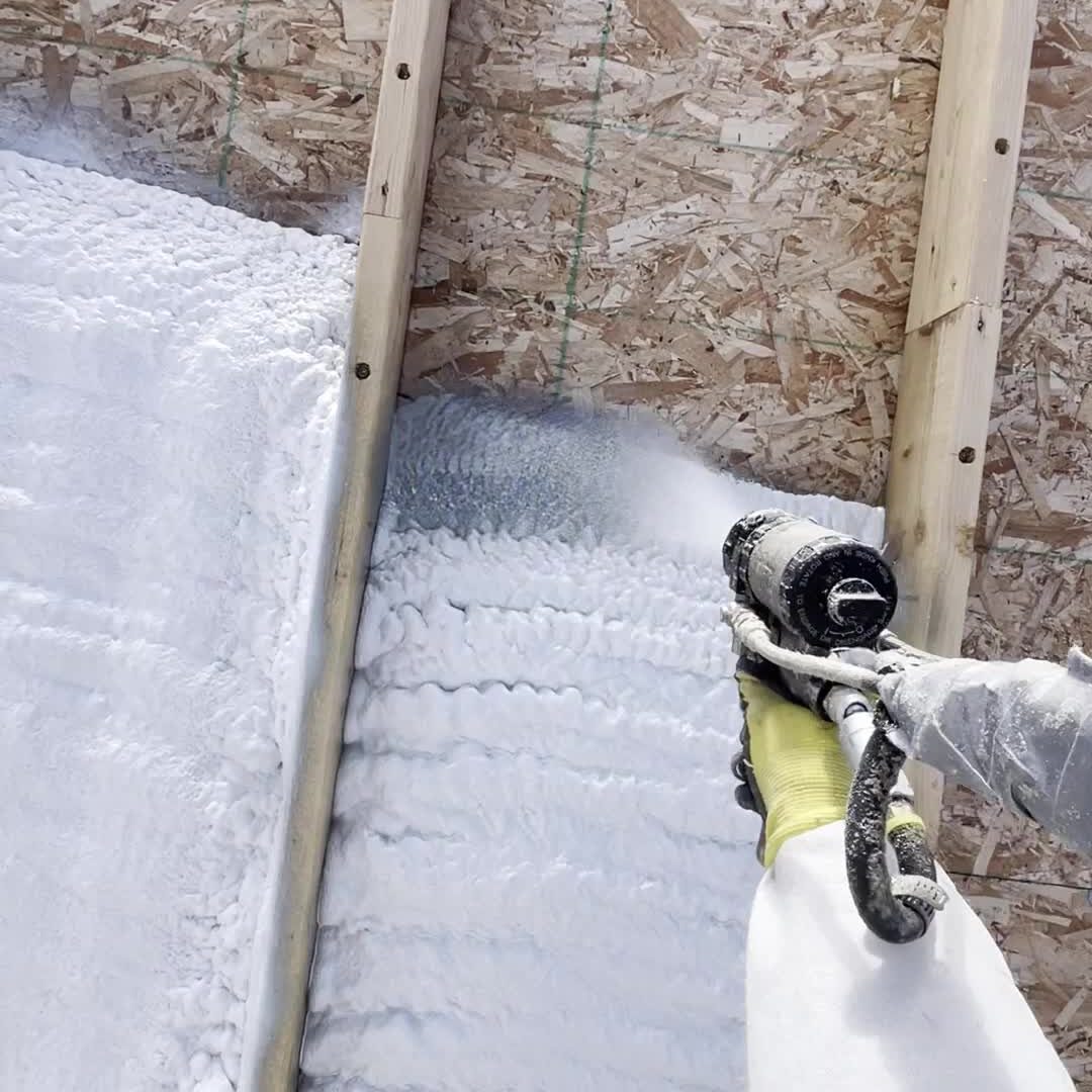 steep roof being covered with foam insulation spray